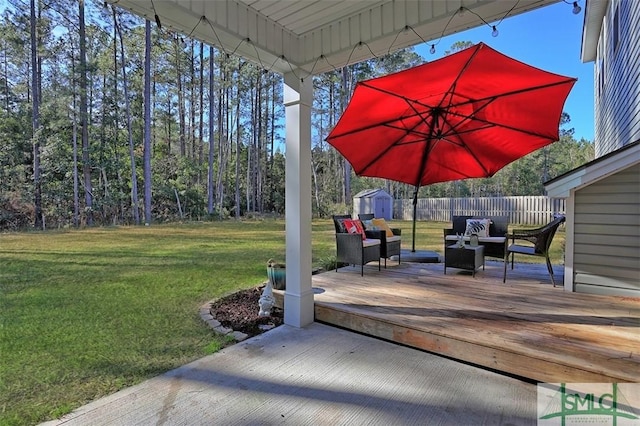 wooden terrace with a storage shed and a lawn