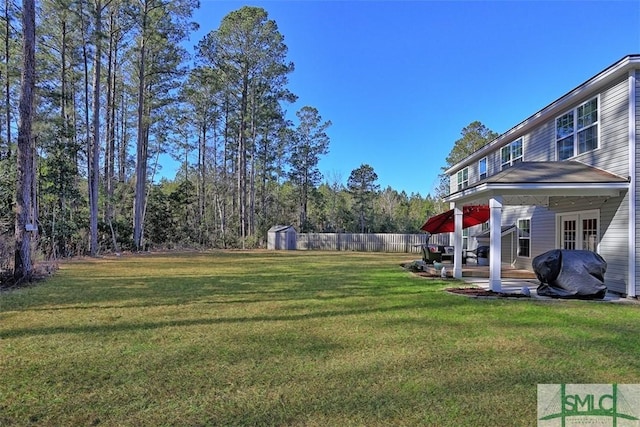 view of yard with a patio area and a storage shed