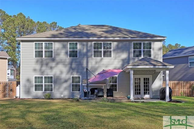 rear view of property featuring a patio area and a yard