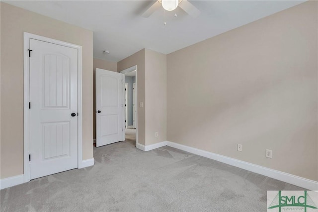 unfurnished bedroom with ceiling fan and light colored carpet