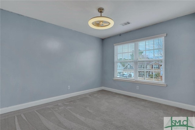 unfurnished room featuring light colored carpet