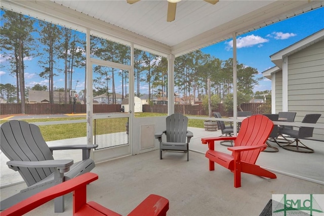 sunroom featuring ceiling fan