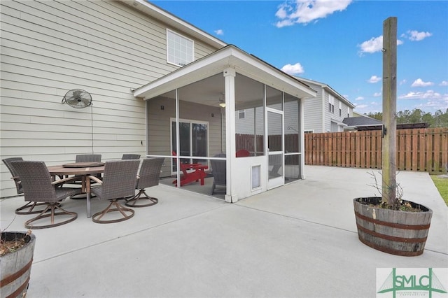 view of patio featuring a sunroom and ceiling fan