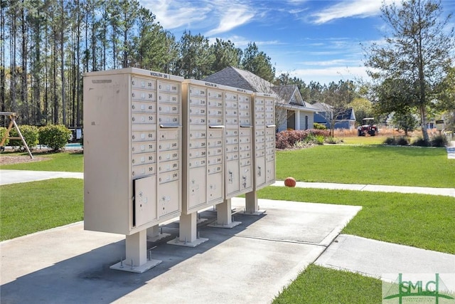 surrounding community with a yard and a mail area