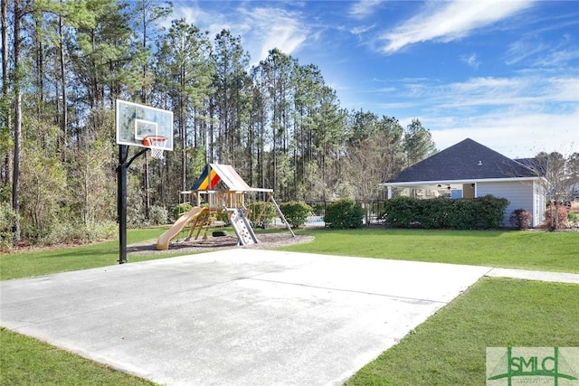 view of sport court featuring a playground and a lawn