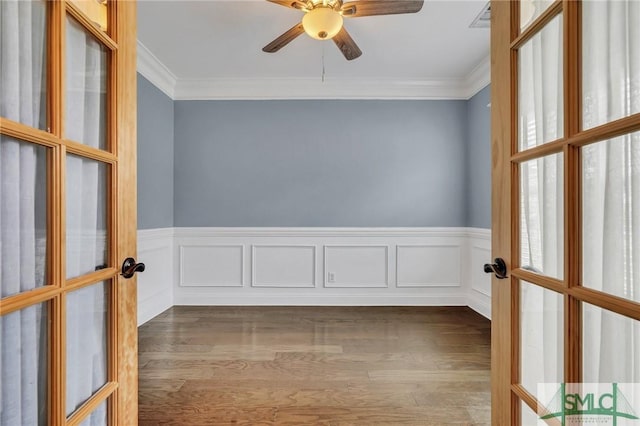 spare room featuring ceiling fan, french doors, crown molding, and dark wood-type flooring