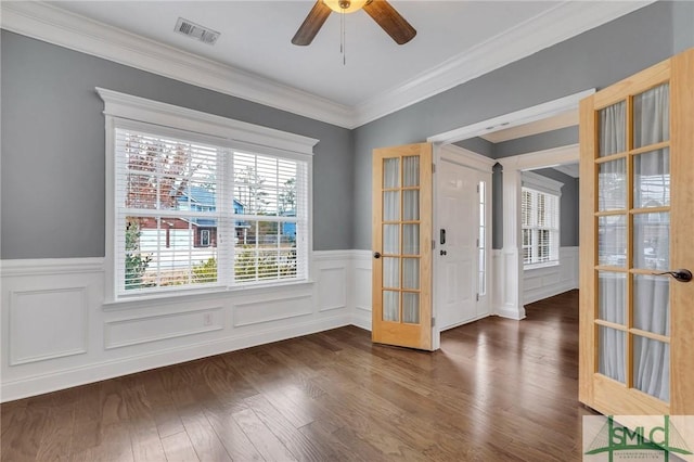 unfurnished room featuring french doors, dark hardwood / wood-style floors, ornamental molding, and plenty of natural light