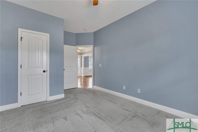 unfurnished bedroom featuring ceiling fan and carpet