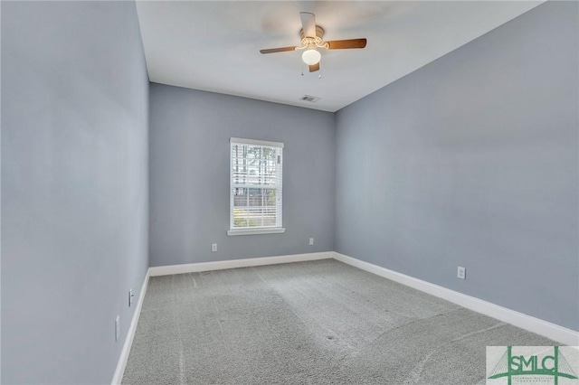 carpeted spare room with ceiling fan