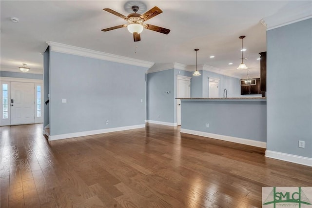 unfurnished living room featuring crown molding, ceiling fan, and dark hardwood / wood-style flooring