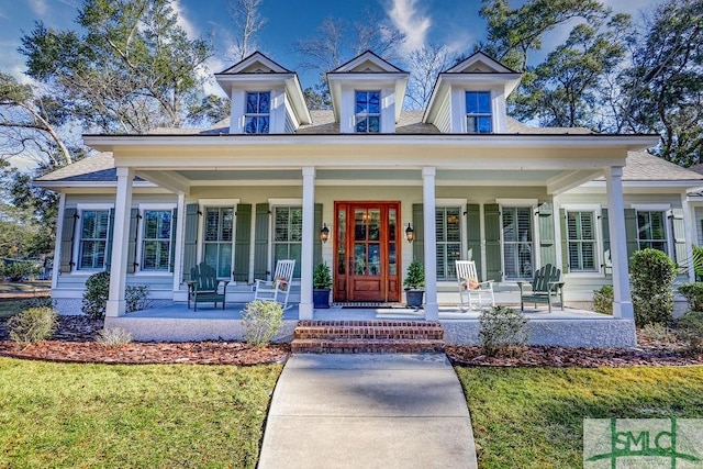 view of front of home featuring covered porch and a front lawn