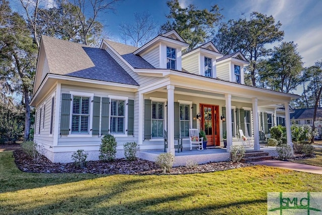 new england style home with covered porch and a front lawn