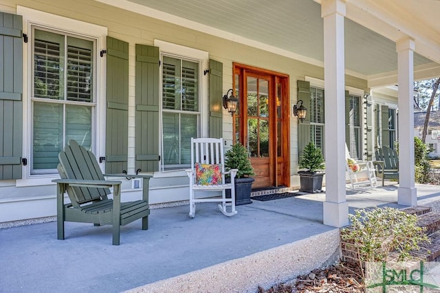 view of exterior entry with a porch