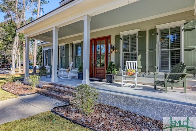 view of exterior entry featuring covered porch