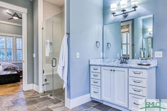 bathroom with an enclosed shower, vanity, and ceiling fan