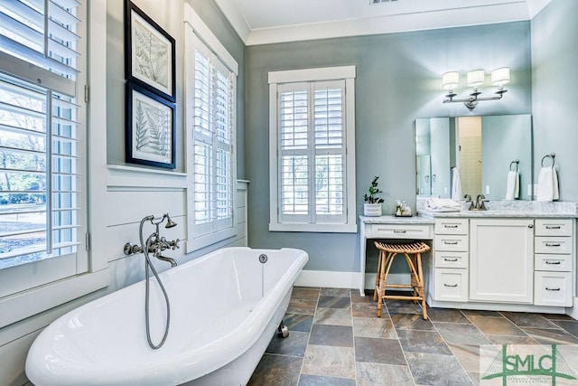 bathroom with vanity, ornamental molding, and a tub to relax in