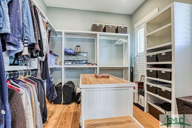 walk in closet with light wood-type flooring