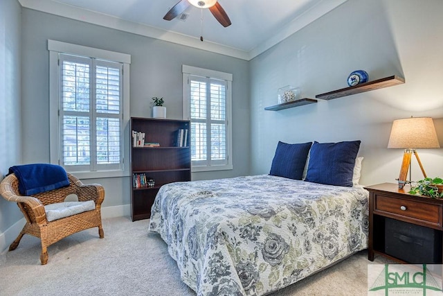 bedroom with multiple windows, ornamental molding, light carpet, and ceiling fan