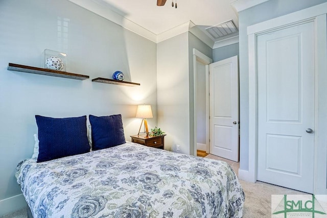 carpeted bedroom with ceiling fan and ornamental molding