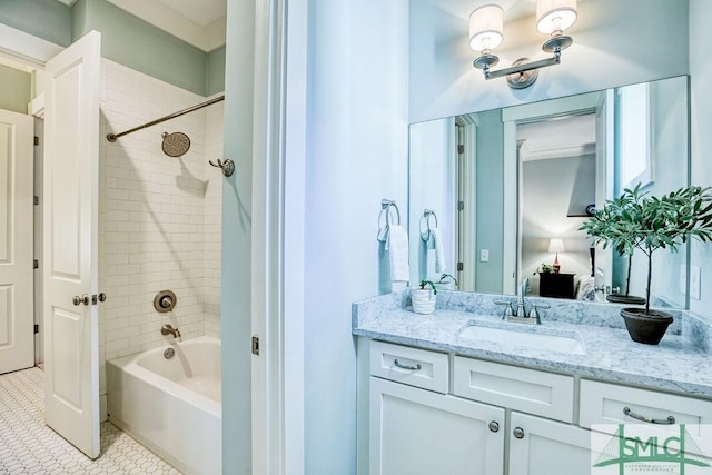 bathroom with tiled shower / bath, vanity, and tile patterned floors