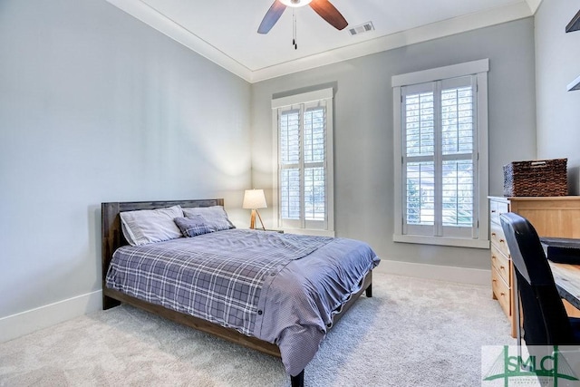 carpeted bedroom featuring crown molding and ceiling fan