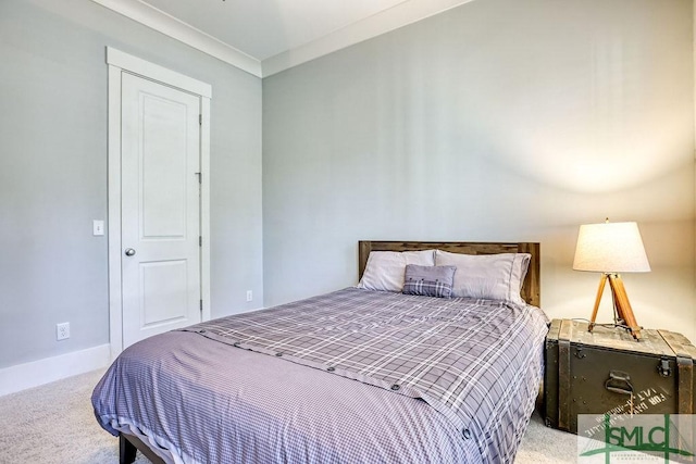 bedroom featuring crown molding and carpet