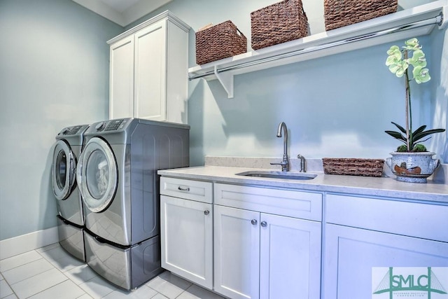 laundry room featuring separate washer and dryer, sink, light tile patterned floors, and cabinets