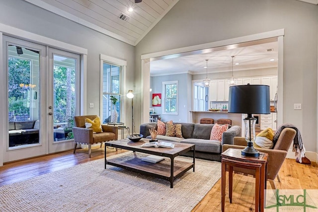 living room with vaulted ceiling, light hardwood / wood-style floors, and wooden ceiling