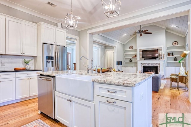 kitchen with appliances with stainless steel finishes and white cabinets