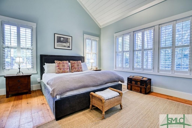 bedroom with lofted ceiling and light hardwood / wood-style floors