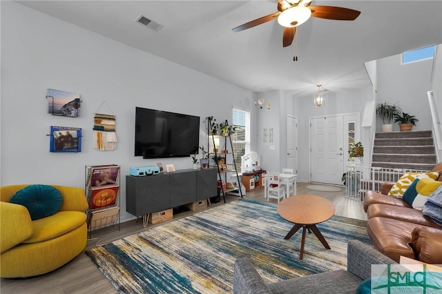 living room featuring hardwood / wood-style floors and ceiling fan