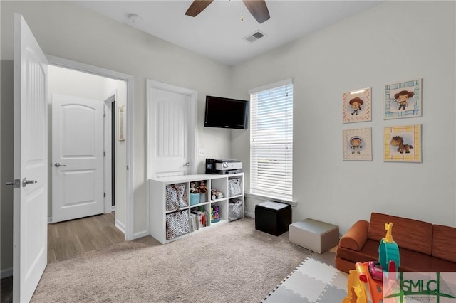 playroom featuring ceiling fan and carpet flooring