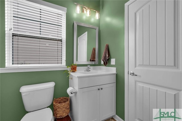 bathroom featuring vanity and toilet