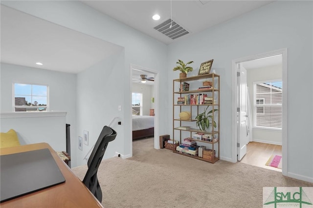 home office featuring ceiling fan and light colored carpet