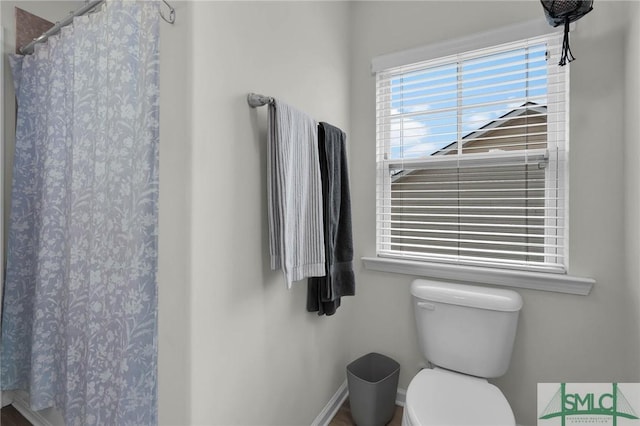 bathroom featuring toilet and walk in shower