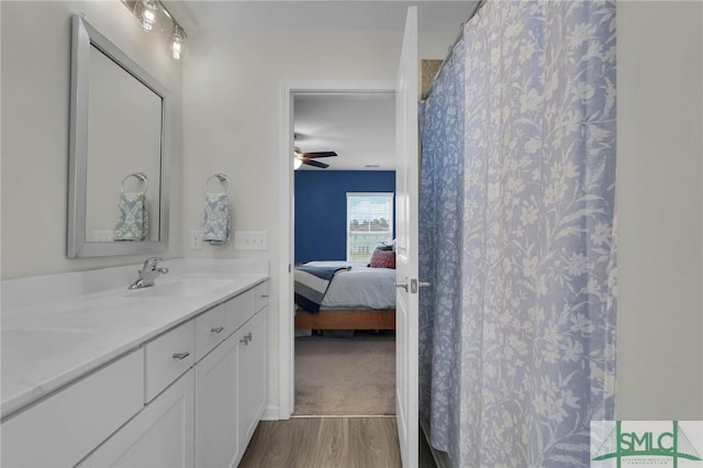 bathroom with vanity, hardwood / wood-style flooring, a shower with curtain, and ceiling fan