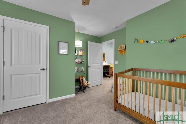 carpeted bedroom featuring a crib