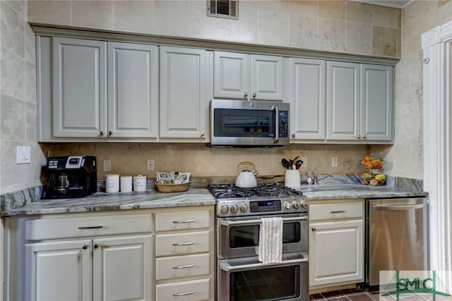 kitchen with light stone countertops and stainless steel appliances