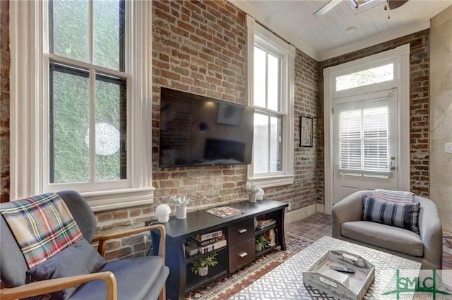 living room with brick wall and ceiling fan