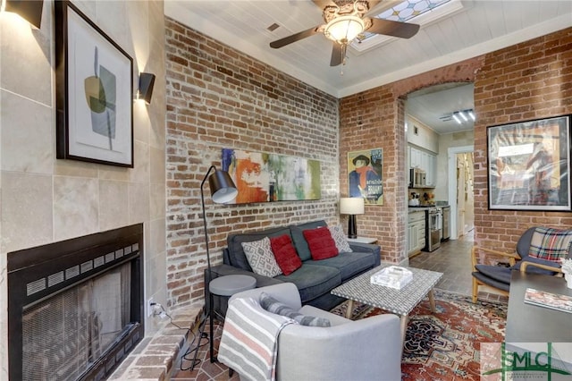 living room with brick wall and wooden ceiling