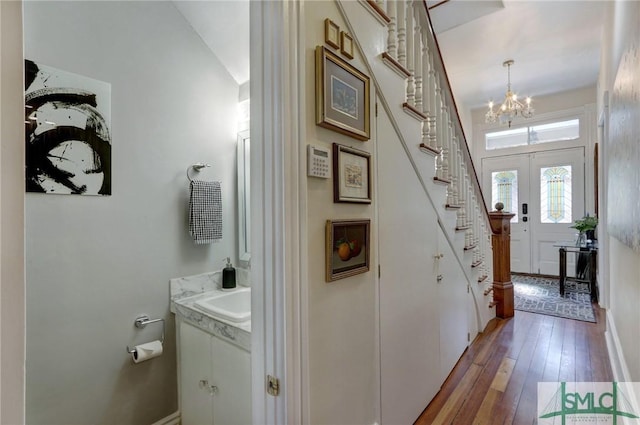 interior space with sink, french doors, a chandelier, and dark hardwood / wood-style flooring