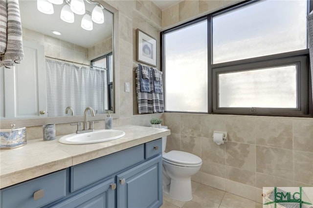 bathroom featuring tile patterned flooring, tile walls, toilet, vanity, and a shower with shower curtain