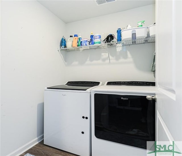 clothes washing area featuring separate washer and dryer and dark hardwood / wood-style flooring