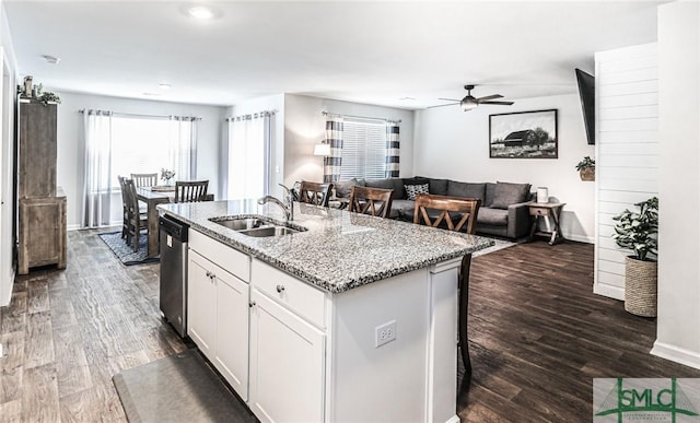 kitchen featuring white cabinets, dishwasher, sink, dark hardwood / wood-style floors, and a center island with sink