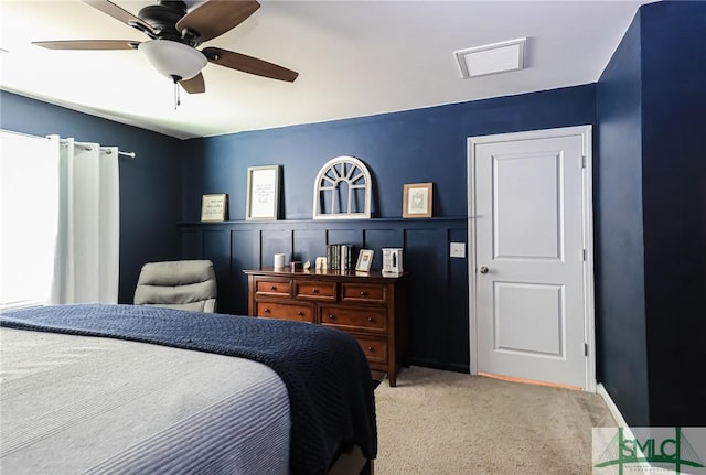 carpeted bedroom featuring multiple windows and ceiling fan