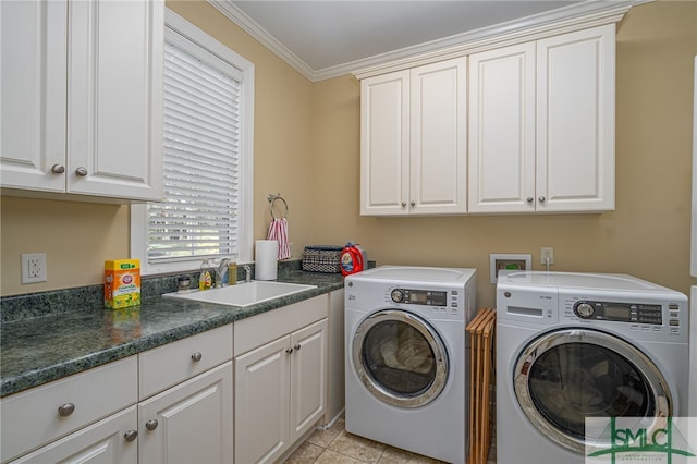 washroom featuring sink, light tile patterned floors, cabinets, ornamental molding, and washer and clothes dryer