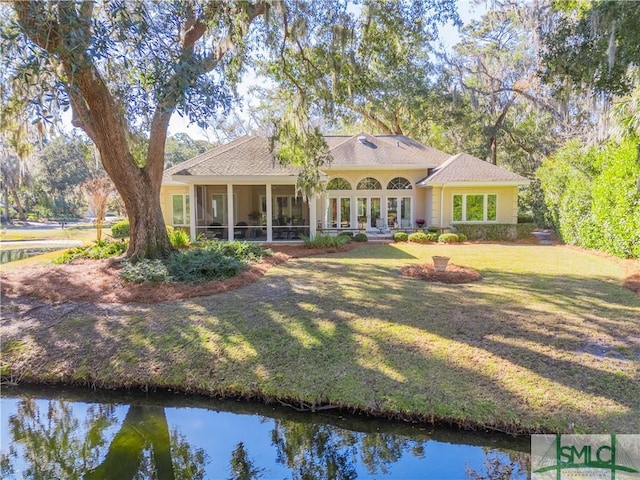 view of front of home with a front lawn and a sunroom