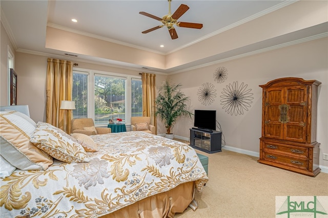 bedroom with ceiling fan, crown molding, light carpet, and a tray ceiling