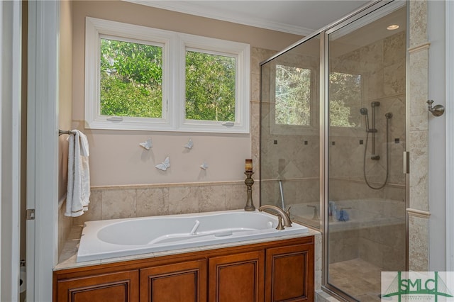 bathroom featuring shower with separate bathtub and ornamental molding