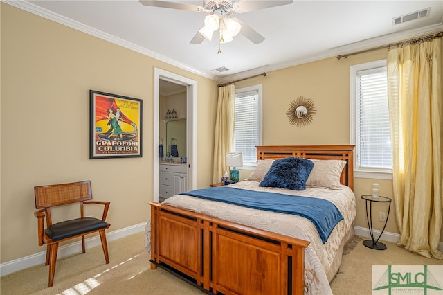 bedroom featuring light carpet, crown molding, ceiling fan, multiple windows, and ensuite bath